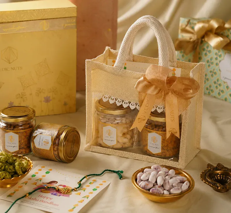 Inside view of Vedic Nuts Rakhi hamper showing handwoven jute potli bags with assorted dry fruits
