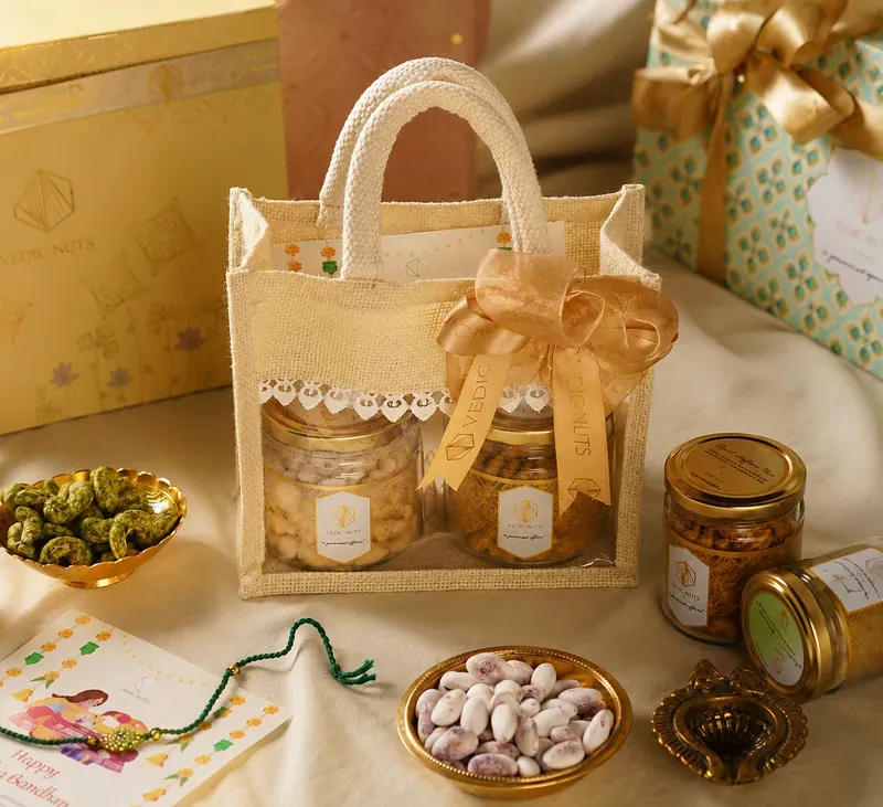 Close-up of Vedic Nuts jute potli Rakhi hamper contents including rakhi, roli chawal, and gourmet nuts