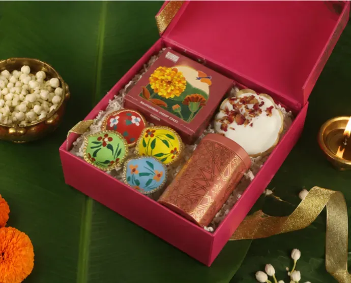 Side view of Shubh Diwali fluorescent festive gift box with neon pink and gold premium packaging