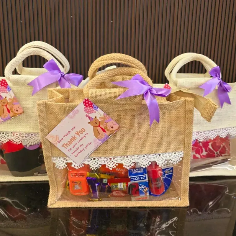 Close-up of festive jute bag hamper contents including premium tea, cookies, and handcrafted chocolates