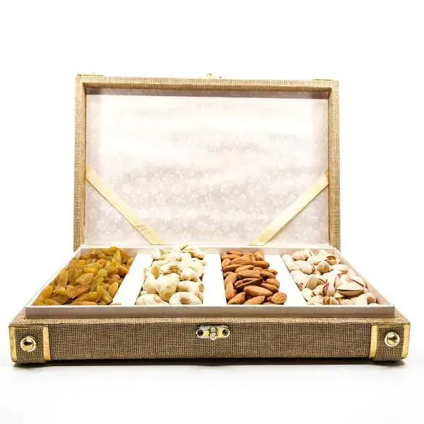 Close-up of textured silk fabric dry fruit gift box with gold embossed branding and satin finish