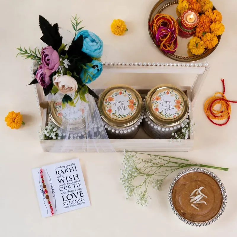 Inside view of floral pinewood Rakhi crate showing hand-painted design and curated gift items