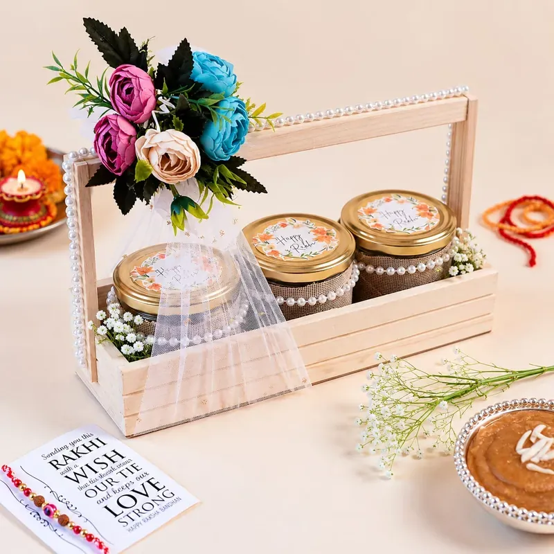 Close-up of floral pinewood Rakhi crate contents including artisanal chocolates and festive sweets