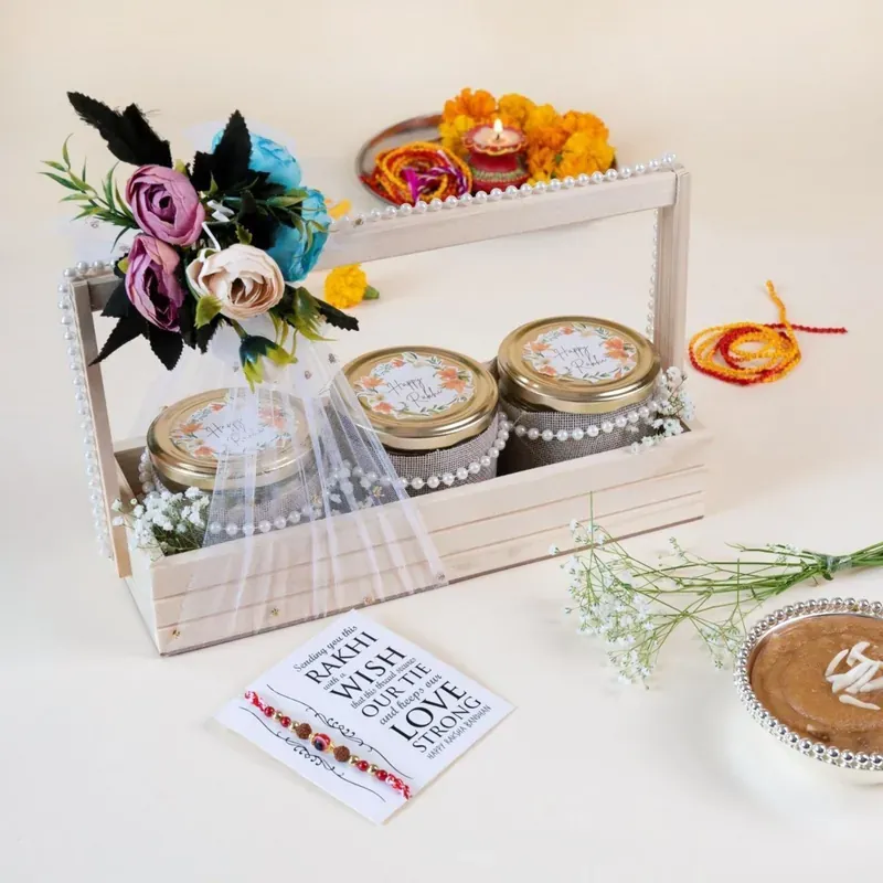Top angle view of rustic floral pinewood Rakhi gift crate with premium packaging and ribbon